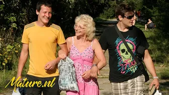 Blonde granny with glasses enjoys outdoor threesome with two young men
